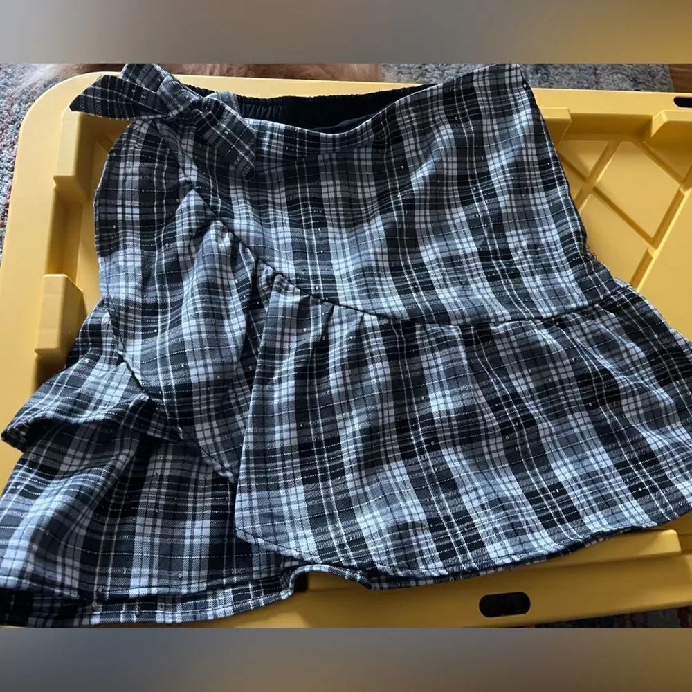 Kidpik Plaid Skirt with attached shorts and bow detail; zipper closure